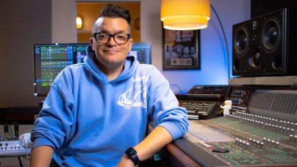 Dana Nielsen sitting at recording console in his studio