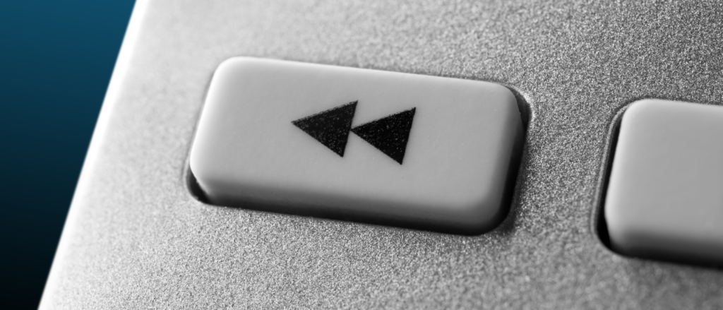 closeup of a rewind button indicated by two triangles pointing left